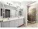 Double vanity bathroom with a separate tiled shower offering functional design and neutral tones at 2890 Wild Ginger Ct, Winter Park, FL 32792