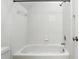 A clean white bathroom showcasing a tiled shower and tub with modern fixtures at 2890 Wild Ginger Ct, Winter Park, FL 32792