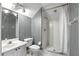 Modern bathroom featuring stylish striped walls and a walk-in shower with glass door at 2890 Wild Ginger Ct, Winter Park, FL 32792