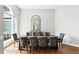 Elegant dining room with hardwood floors, stylish furnishings, and an arched mirror accent at 2890 Wild Ginger Ct, Winter Park, FL 32792
