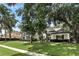 Beautiful home exterior featuring manicured lawn, mature trees, and a sidewalk leading to the front entrance at 2890 Wild Ginger Ct, Winter Park, FL 32792