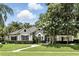 Attractive single-story house with a landscaped front yard, decorative shrubbery, and a concrete walkway at 2890 Wild Ginger Ct, Winter Park, FL 32792