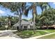 Stylish single-story house featuring a lush lawn, mature landscaping, and an attached two-car garage at 2890 Wild Ginger Ct, Winter Park, FL 32792