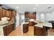 Charming kitchen featuring wooden cabinets, granite countertops, stainless steel appliances, and hardwood flooring at 2890 Wild Ginger Ct, Winter Park, FL 32792