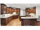 Well-appointed kitchen featuring granite countertops, stainless steel appliances, and custom wood cabinetry throughout at 2890 Wild Ginger Ct, Winter Park, FL 32792