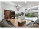 Comfortable living room with fireplace, built-in shelving, and views of the pool and garden beyond at 2890 Wild Ginger Ct, Winter Park, FL 32792