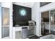 Covered outdoor kitchen area featuring a stainless steel grill and refrigerator for convenient entertaining at 2890 Wild Ginger Ct, Winter Park, FL 32792