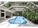 Inviting screened-in pool with lush landscaping, creating a private backyard oasis at 2890 Wild Ginger Ct, Winter Park, FL 32792