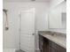 Bathroom with granite countertop, modern sink, shower with detachable head, and white door at 3110 Areca Ave, New Smyrna Beach, FL 32168