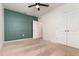 Spacious bedroom with stylish wainscoting, carpeted floors, ceiling fan, and double door closet at 3110 Areca Ave, New Smyrna Beach, FL 32168