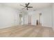 Large bedroom with neutral tones, featuring multiple doorways and a ceiling fan at 3110 Areca Ave, New Smyrna Beach, FL 32168