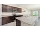Modern kitchen with granite countertops, stainless steel appliances and a breakfast bar at 3110 Areca Ave, New Smyrna Beach, FL 32168