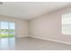 Bright living space with tile floors, large window and neutral wall colors at 3110 Areca Ave, New Smyrna Beach, FL 32168