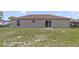 Home backyard featuring a partially grassed yard with a sliding glass door at 3313 Buckland St, Deltona, FL 32738