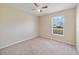 Comfortable bedroom with a ceiling fan, neutral walls, carpet, and natural light at 3313 Buckland St, Deltona, FL 32738