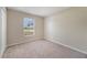 Cozy bedroom featuring neutral walls, carpeted floors, and a bright window at 3313 Buckland St, Deltona, FL 32738
