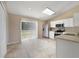 Well-lit kitchen with stainless steel appliances, white cabinets, and sliding glass doors at 3313 Buckland St, Deltona, FL 32738