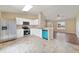Open kitchen layout with stainless steel appliances and tile flooring overlooking the living area at 3313 Buckland St, Deltona, FL 32738