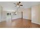 Open-concept living room with tile flooring, ceiling fan, and a view of the kitchen at 3313 Buckland St, Deltona, FL 32738