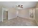 Spacious main bedroom with tile flooring, a ceiling fan, and ensuite bathroom access at 3313 Buckland St, Deltona, FL 32738