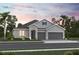 Charming two-story home with stone accents, a three-car garage and manicured landscaping at 3492 Lemon Button Ter, Apopka, FL 32712