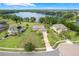 Aerial view of a landscaped property with a long driveway leading to a beautiful home near the lake at 3531 Oriskany Dr, Orlando, FL 32820