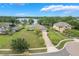 Aerial view of a home with a long driveway, lush landscaping, and a scenic lake backdrop at 3531 Oriskany Dr, Orlando, FL 32820