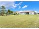 Expansive backyard featuring a well-maintained lawn and a view of a neighboring home at 3531 Oriskany Dr, Orlando, FL 32820