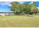 Lush backyard with a wooden walkway leading to a dock and tranquil lake views at 3531 Oriskany Dr, Orlando, FL 32820