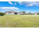 Expansive backyard featuring lush green grass and views of the neighboring houses at 3531 Oriskany Dr, Orlando, FL 32820