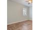 Bright bedroom featuring stylish herringbone floors and natural light from the window at 3531 Oriskany Dr, Orlando, FL 32820