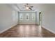 A spacious bedroom with lots of natural light and light hardwood floors in a modern herringbone pattern at 3531 Oriskany Dr, Orlando, FL 32820