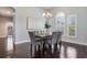 Cozy dining room with hardwood floors, elegant lighting, and a view of the outdoors at 3531 Oriskany Dr, Orlando, FL 32820