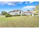 Stunning single-story home with a well-manicured lawn and beautiful landscaping on a sunny day at 3531 Oriskany Dr, Orlando, FL 32820