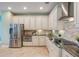Bright kitchen featuring stainless steel appliances, light cabinets, granite countertops, and a stylish backsplash at 3531 Oriskany Dr, Orlando, FL 32820
