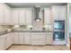 The kitchen features white cabinets, stainless steel appliances and granite countertops at 3531 Oriskany Dr, Orlando, FL 32820