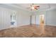 Bright main bedroom with a herringbone floor, slider to patio, and ensuite bathroom access at 3531 Oriskany Dr, Orlando, FL 32820