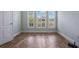 Well-lit room with herringbone wood flooring and plantation shutters on a bright and sunny day at 3531 Oriskany Dr, Orlando, FL 32820