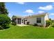 Well-maintained backyard featuring a screened lanai, green lawn, and neat landscaping at 3531 Reston Dr, The Villages, FL 32162