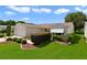 Attractive home exterior featuring a well-manicured lawn and attached garage at 3531 Reston Dr, The Villages, FL 32162