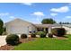 Charming one-story home featuring a well-maintained lawn, attractive landscaping, and a classic exterior design at 3531 Reston Dr, The Villages, FL 32162