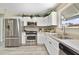 Well-lit kitchen with stainless steel appliances, ample cabinet space, and modern sink at 3531 Reston Dr, The Villages, FL 32162