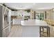 Open kitchen area with breakfast bar, modern appliances, and a view of the dining space at 3531 Reston Dr, The Villages, FL 32162