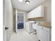 Laundry room with white cabinets, a utility sink, and a washer and dryer at 3531 Reston Dr, The Villages, FL 32162