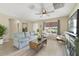 Cozy living room with comfortable seating, a ceiling fan, and bright natural light at 3531 Reston Dr, The Villages, FL 32162