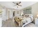 Spacious main bedroom featuring contemporary design elements, ceiling fan, and adjacent closets at 3531 Reston Dr, The Villages, FL 32162