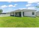 Lush backyard showcasing the screened-in patio and exterior features of this single Gathering home at 3866 Cabo Rojo Dr, St Cloud, FL 34772