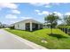 Well-maintained backyard, complete with a screened-in patio area, green grass and a black fence at 3866 Cabo Rojo Dr, St Cloud, FL 34772