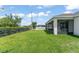 Large grassy backyard, perfect for recreation and relaxation, with a screened-in patio attached to the home at 3866 Cabo Rojo Dr, St Cloud, FL 34772