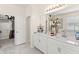 Well-lit bathroom featuring double sinks, bathtub, and walk-in closet at 3866 Cabo Rojo Dr, St Cloud, FL 34772